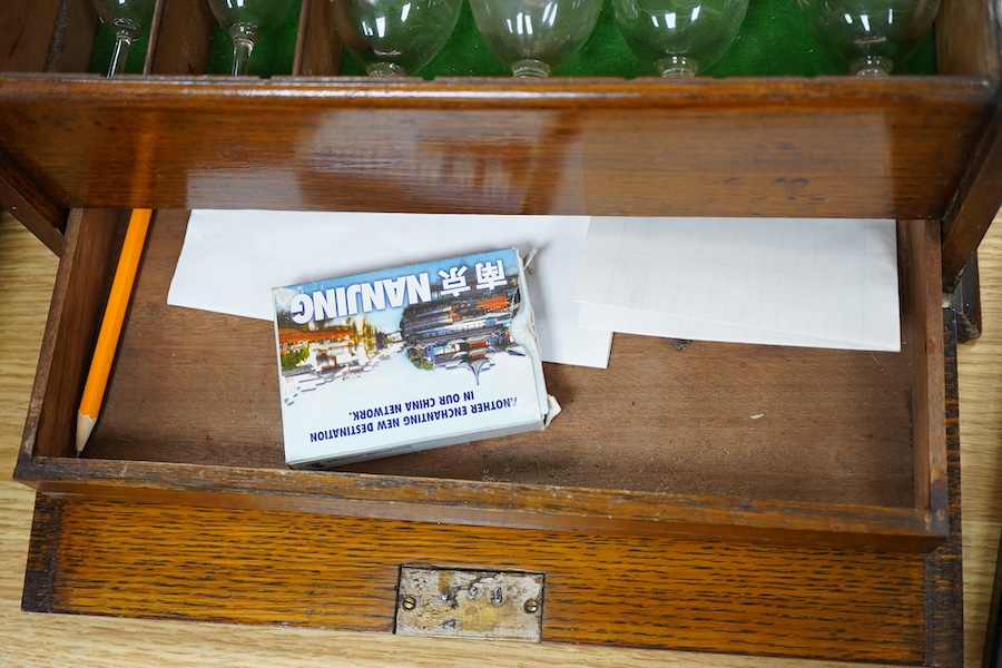 A Victorian oak three-bottle tantalus, with compartment for glasses, 30cm high x 34cm wide